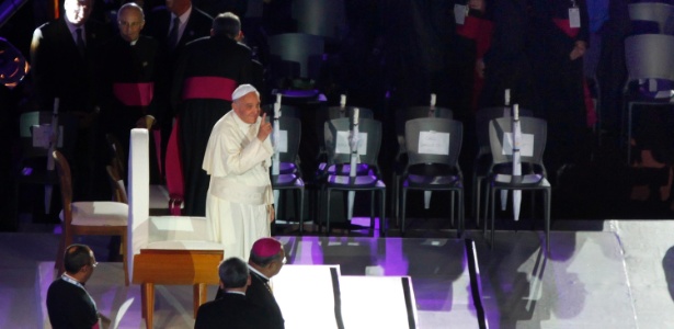 O papa Francisco aponta para o céu para mostrar aos peregrinos que a chuva deu trégua logo que chegou ao palco montado em Copacabana