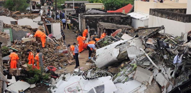 24.jul.2014 - Equipes de resgate e bombeiros investigam os destroços do voo GE222