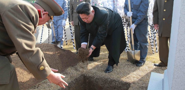 O líder da Coreia do Norte, Kim Jong-un, joga terra em túmulo de chefe militar norte-coreano, no Cemitério dos Mártires Revolucionários em Monte Taesong, próximo a Pyongyang