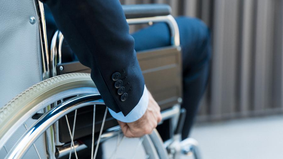 Imagem de banco mostra homem de negócios em cadeira de rodas
