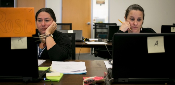 19.jun.2015 - Rose Rodriguez-Rabin (esq) e Valerie Gomm (dir) corrigem provas em um escritório da Pearson em San Antonio, no Texas (EUA)